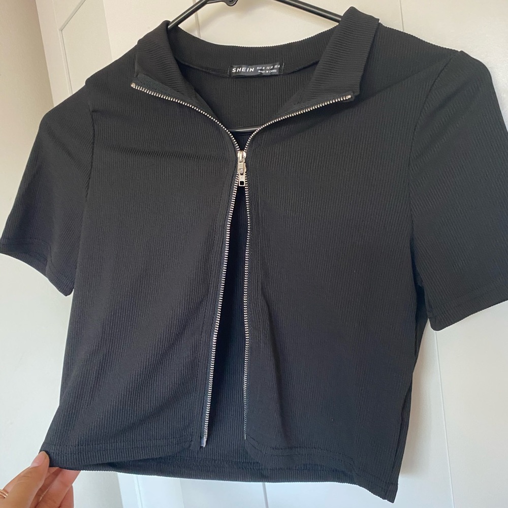 Cropped zip up black shirt.